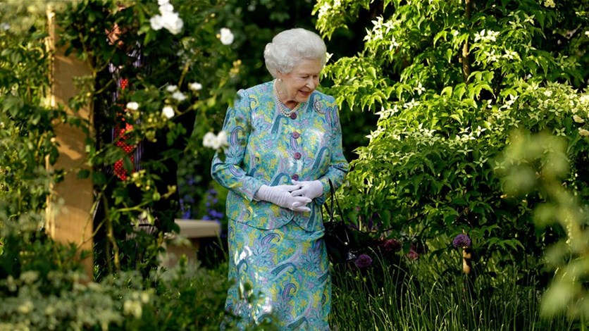 الملكة إليزابيث الثانية تتأكد من جودة عمل البستاني واهتمامه بحديقة القصر