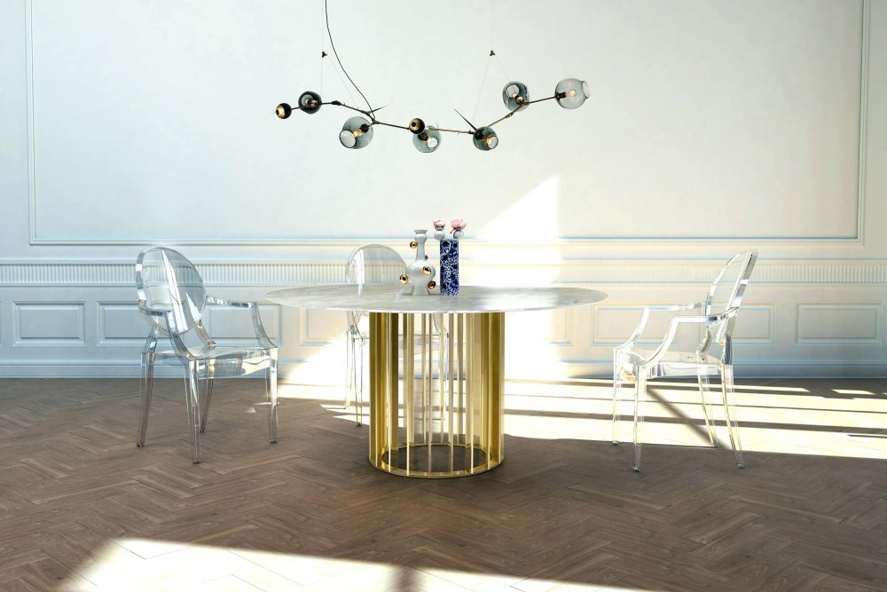 طاولة طعام مصممة بشكل دائري بسيط تعتمد الرخام مع اللون الذهبي البراق