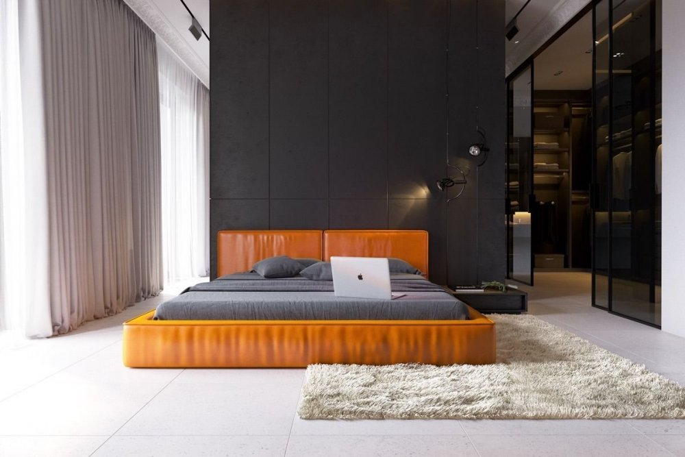 سرير باللون البرتقالي الجريء لديكور غرفة نوم تعتمد اللون الأسود والأبيض
